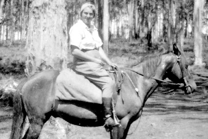 May Alderson sitting on horseback in the bush